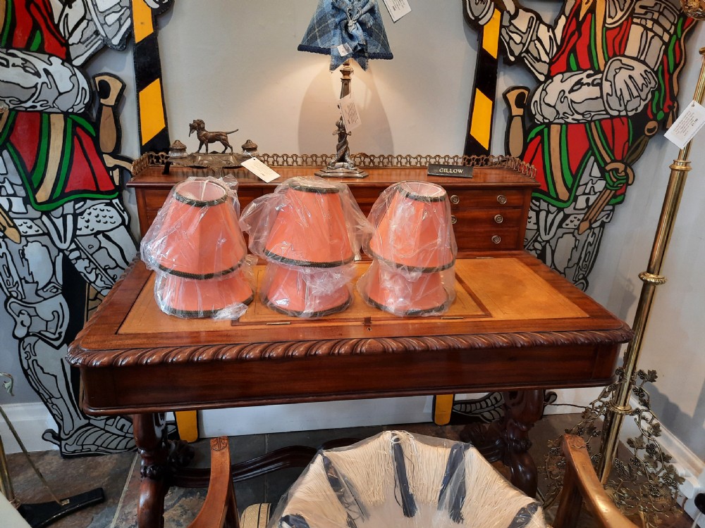 A pair of late nineteenth-century dark spelter table lamps featuring detailed cast musketeer figures supporting pike shafts fitted with cream shades. View II