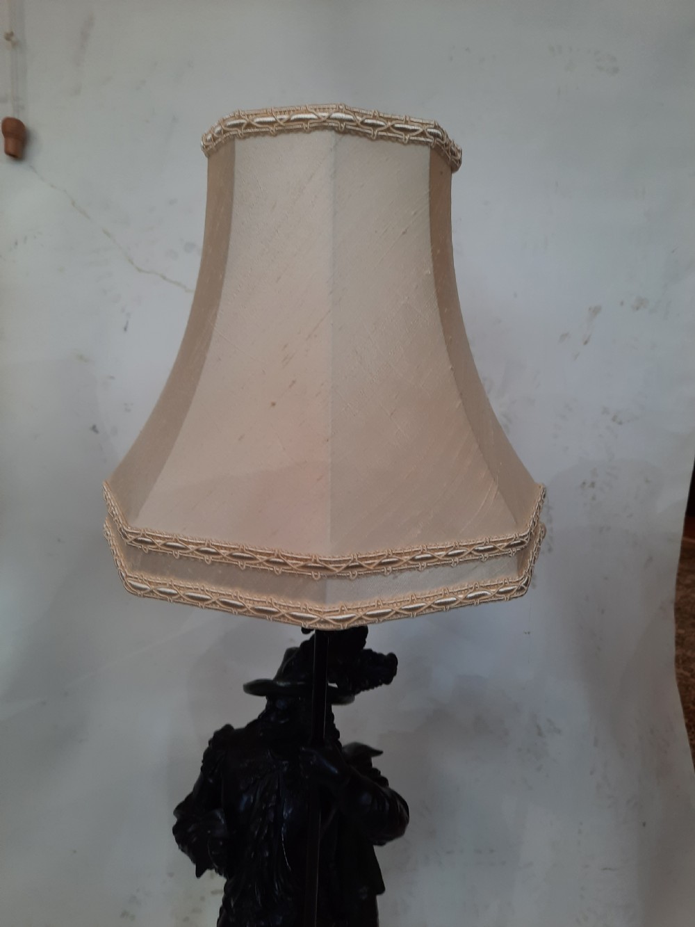 A pair of late nineteenth-century dark spelter table lamps featuring detailed cast musketeer figures supporting pike shafts fitted with cream shades. View VIII