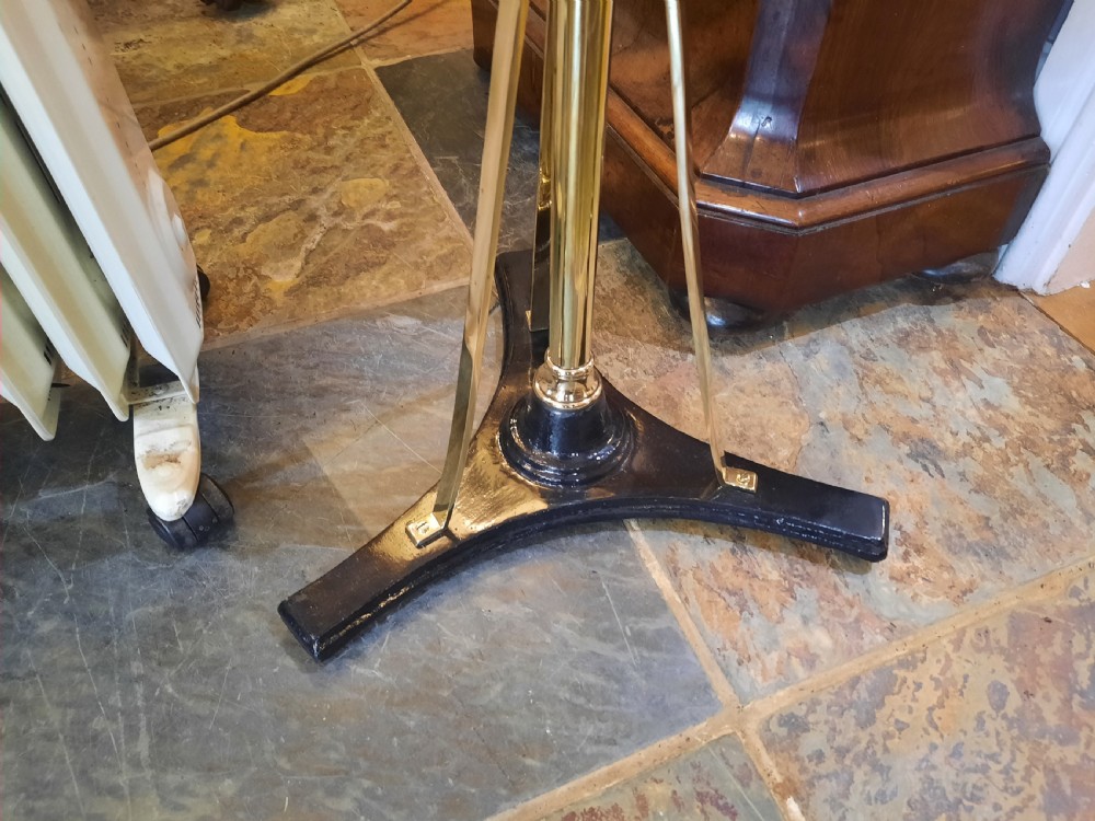 A nineteenth-century brass telescopic shaving stand featuring a diamond-shaped mirror, two candle sconces, a small circular tray, and a tripod base. View II