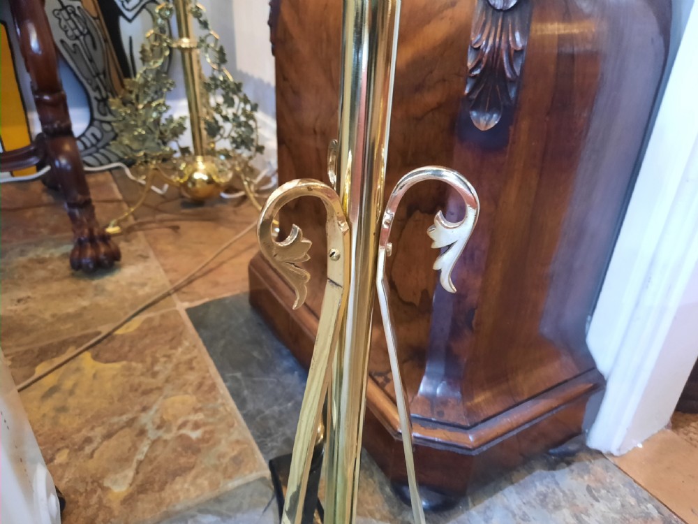 A nineteenth-century brass telescopic shaving stand featuring a diamond-shaped mirror, two candle sconces, a small circular tray, and a tripod base. View III