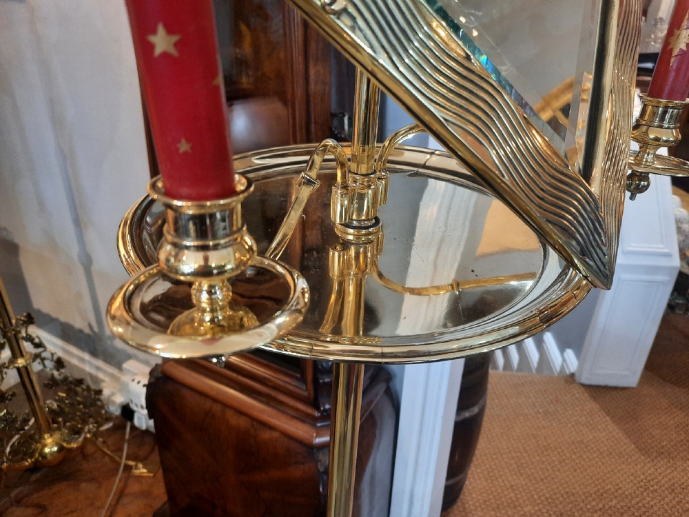 A nineteenth-century brass telescopic shaving stand featuring a diamond-shaped mirror, two candle sconces, a small circular tray, and a tripod base. View IV