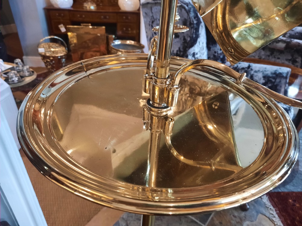 A nineteenth-century brass telescopic shaving stand featuring a diamond-shaped mirror, two candle sconces, a small circular tray, and a tripod base. View VI
