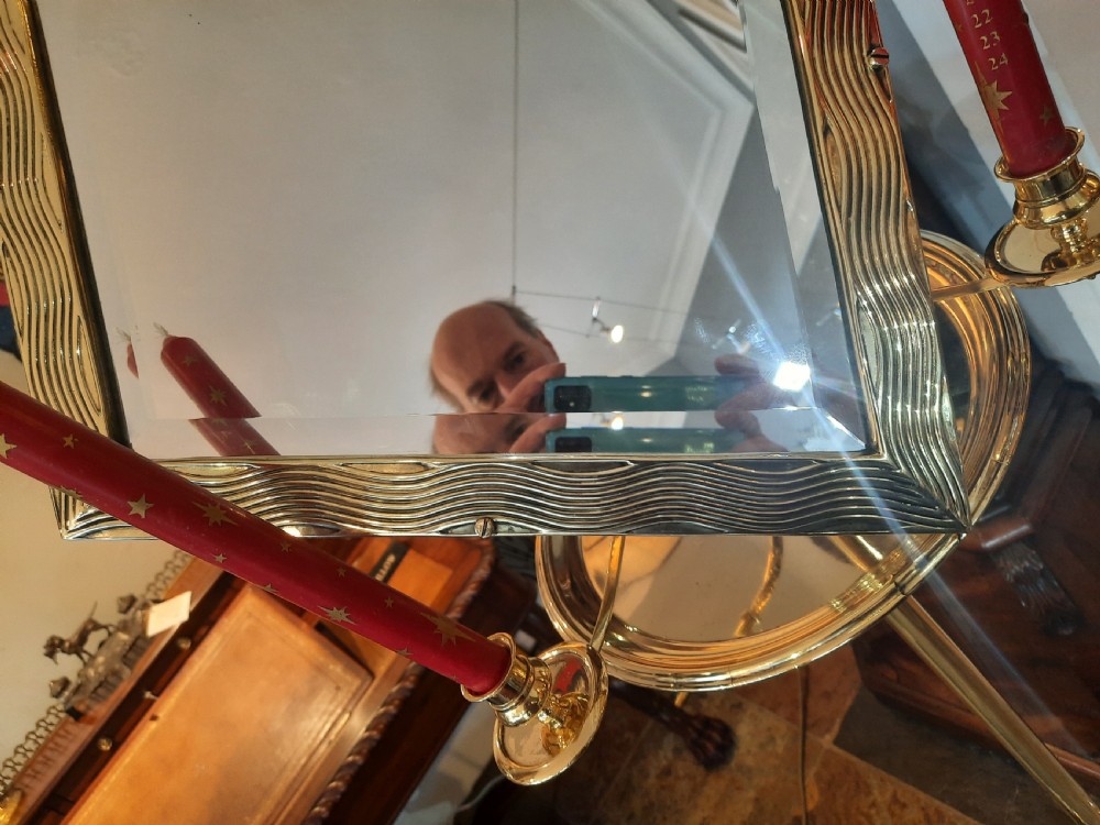 A nineteenth-century brass telescopic shaving stand featuring a diamond-shaped mirror, two candle sconces, a small circular tray, and a tripod base. View VII