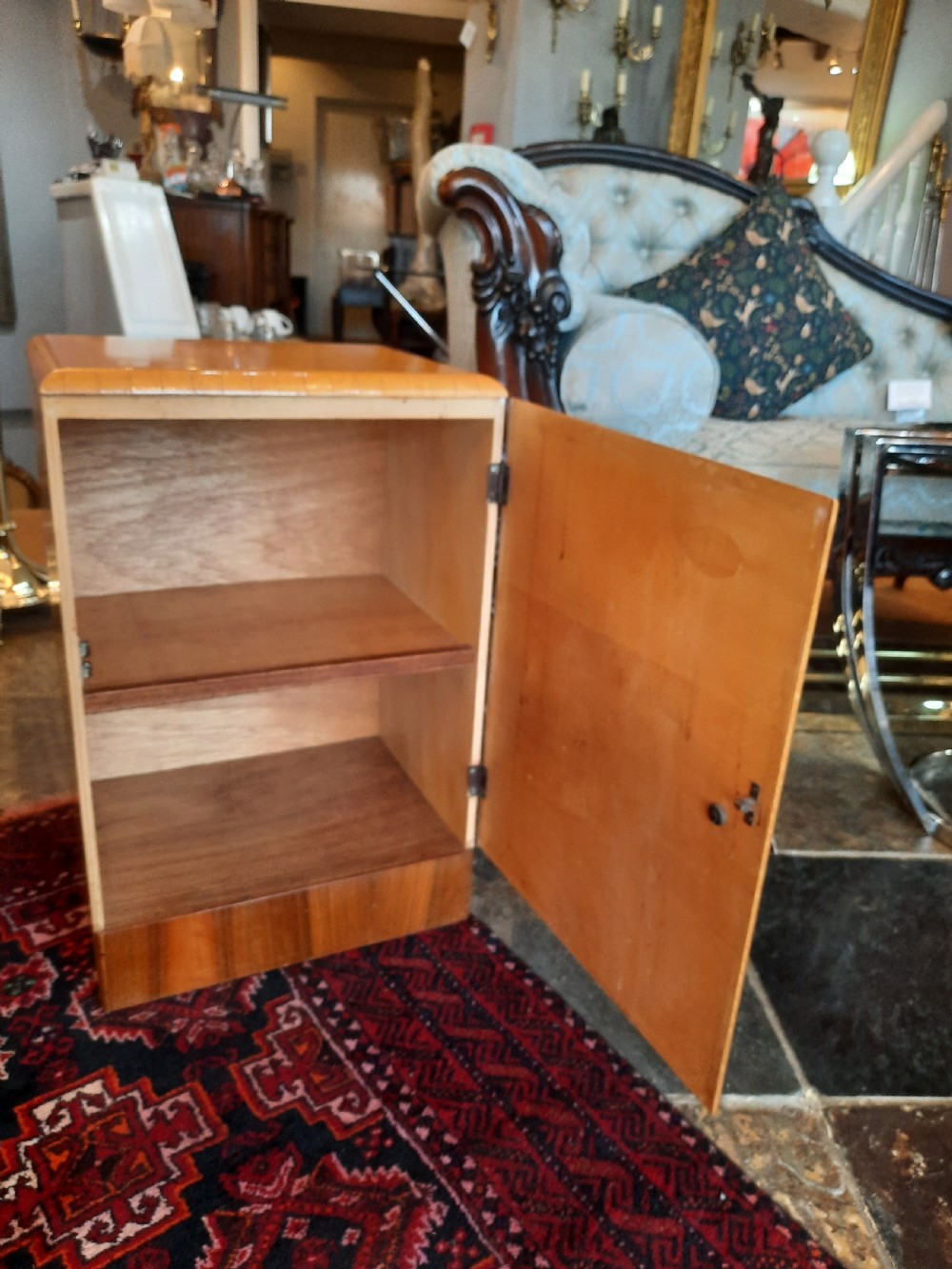 A pair of Art Deco bedside cabinets featuring golden parchment door fronts, contrast dark wood plinths, and small metal handles. View III