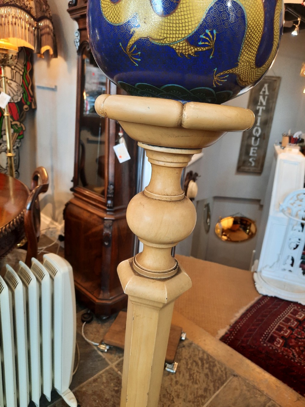 A 1920s painted cream wooden standard lamp featuring a central blue decorated ceramic vase, a gooseneck brass arm, and a fabric lampshade with beaded fringe. View VI
