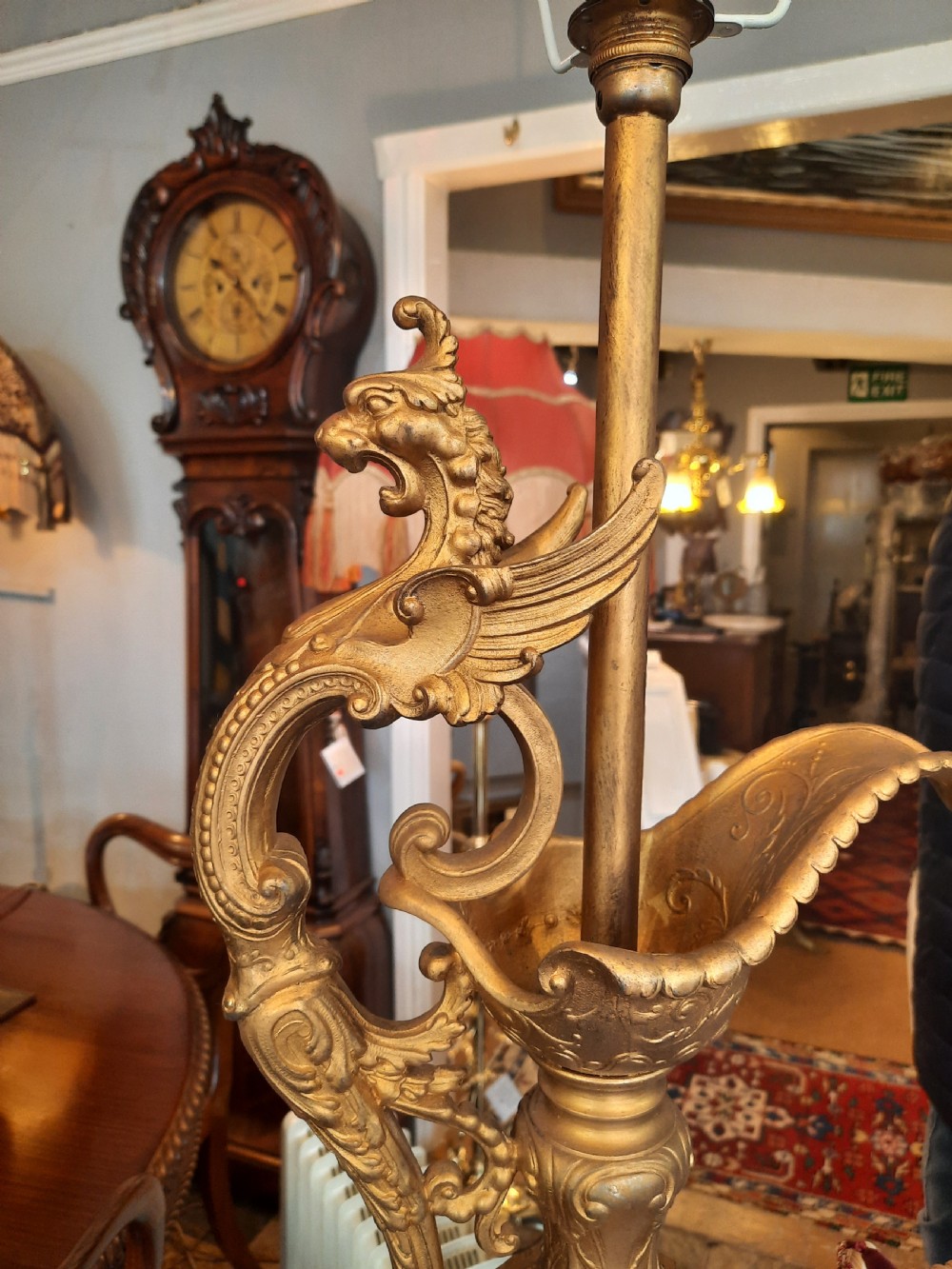 A pair of late nineteenth-century cobalt blue glass ewer lamps with ornate gilt bronze mounts and cream fabric shades featuring fringe and bead tassels. View VIII