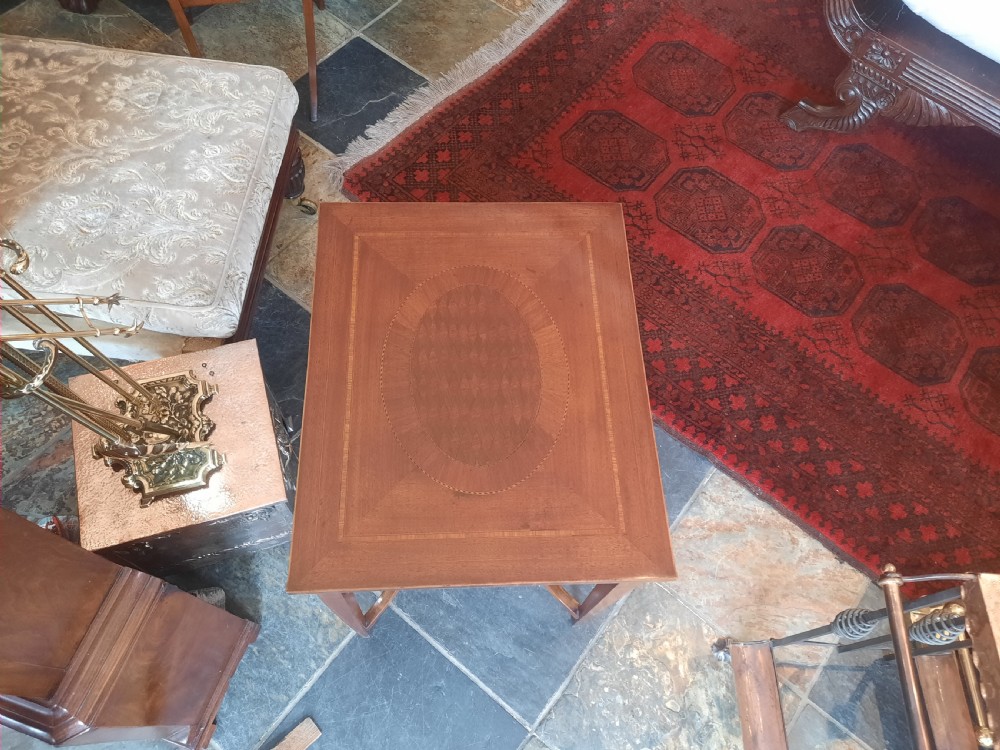An Edwardian rectangular mahogany side table with satinwood inlaid crossbanding, slender tapered legs, and a small central undertier. View II