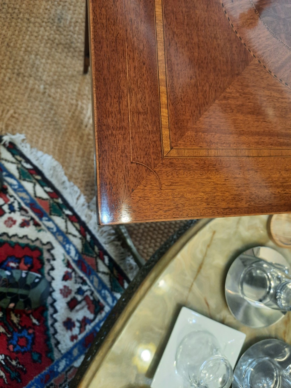 An Edwardian rectangular mahogany side table with satinwood inlaid crossbanding, slender tapered legs, and a small central undertier. View III