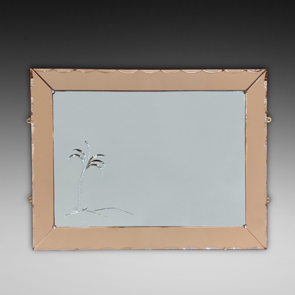 A rectangular Art Deco wall mirror featuring a peach-tinted glass border with scalloped outer edges and an etched palm tree design in the bottom corner.