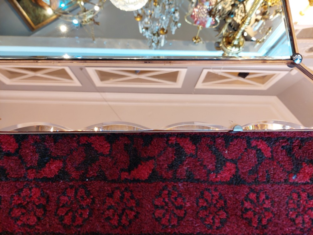 A rectangular Art Deco wall mirror featuring a peach-tinted glass border with scalloped outer edges and an etched palm tree design in the bottom corner. View III