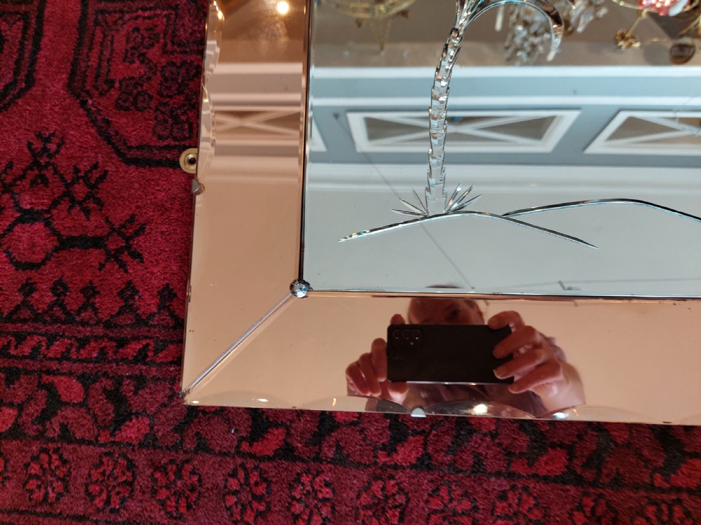 A rectangular Art Deco wall mirror featuring a peach-tinted glass border with scalloped outer edges and an etched palm tree design in the bottom corner. View IV