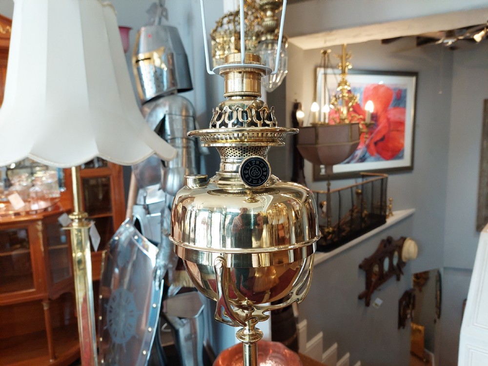 An Art Nouveau brass adjustable standard lamp with a tripod base, telescopic central stem, and a cream fringed fabric shade. View III