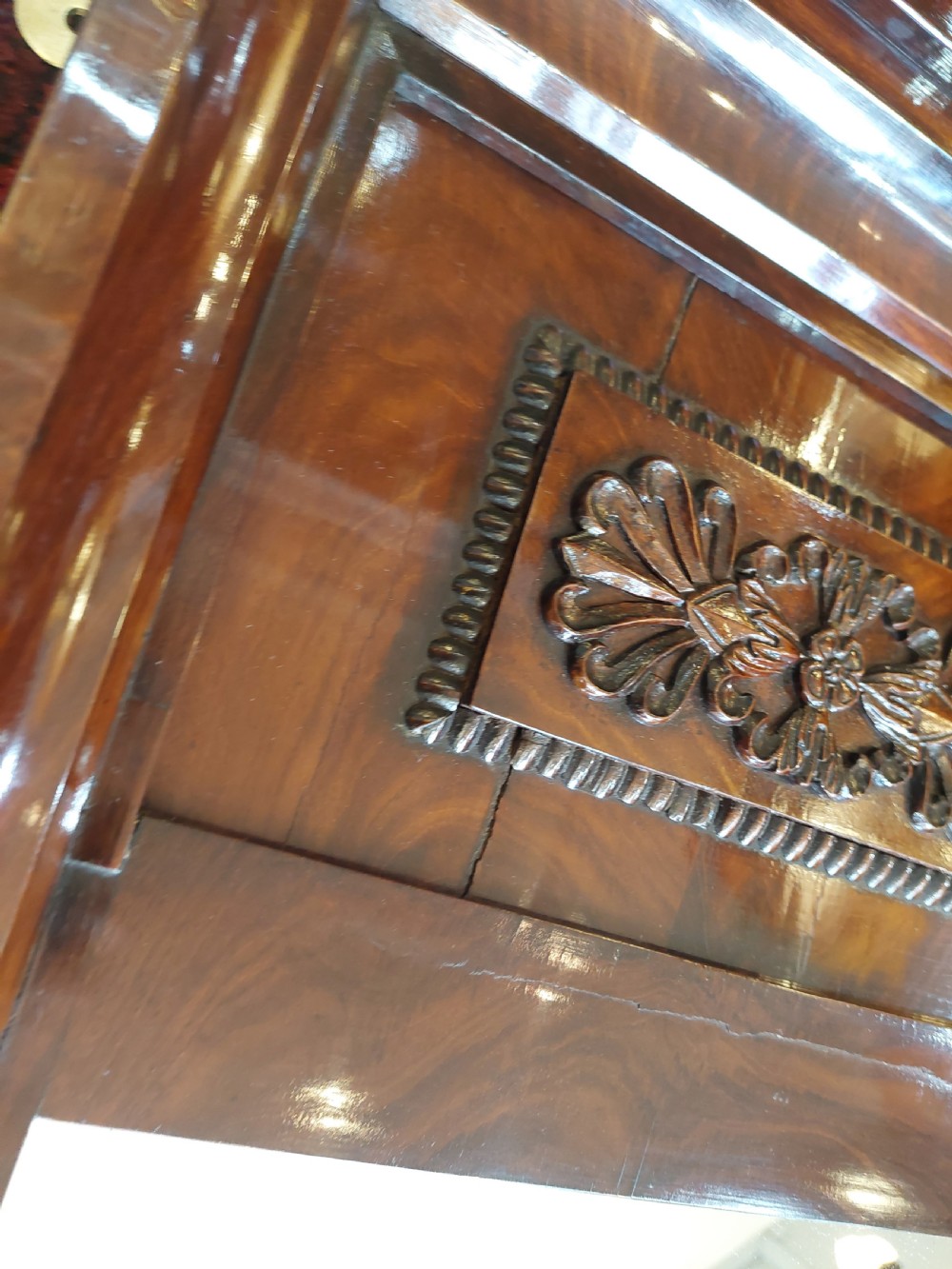 A tall early nineteenth-century Biedermeier mahogany pier mirror featuring a stepped top cornice, a carved floral frieze panel, and a rectangular glass plate. View III