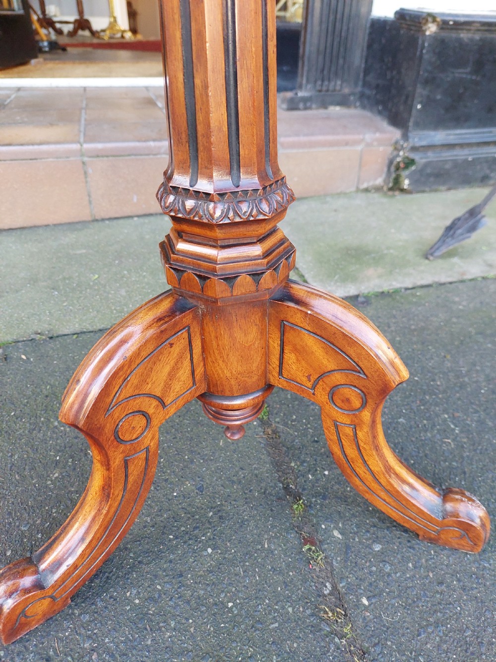 An antique Victorian Gothic mahogany tripod side table with an octagonal top, fluted central column, and three carved decorative legs. View IV