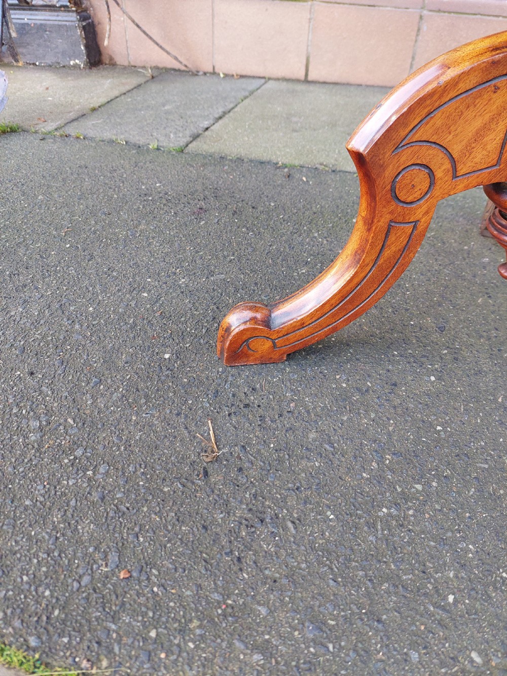 An antique Victorian Gothic mahogany tripod side table with an octagonal top, fluted central column, and three carved decorative legs. View VII