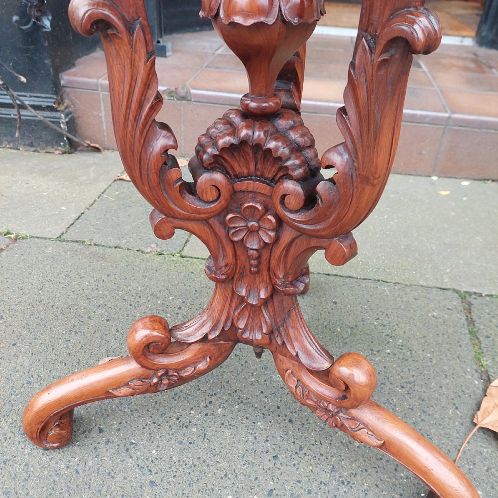 A 19th-century octagonal yew wood work table featuring a hinged top lid, a tapered central body, and carved tripod legs. View III