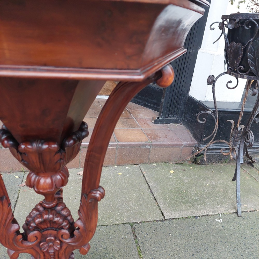 A 19th-century octagonal yew wood work table featuring a hinged top lid, a tapered central body, and carved tripod legs. View VII