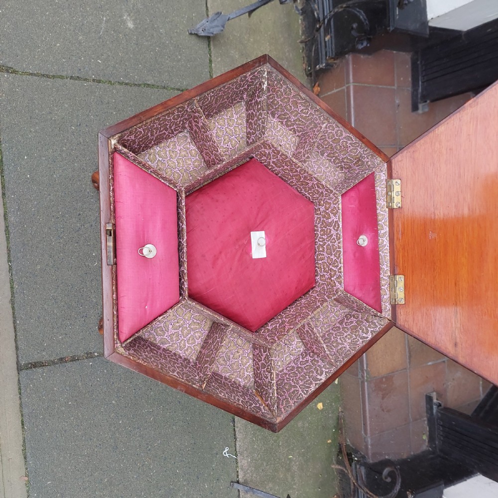 A 19th-century octagonal yew wood work table featuring a hinged top lid, a tapered central body, and carved tripod legs. View VIII