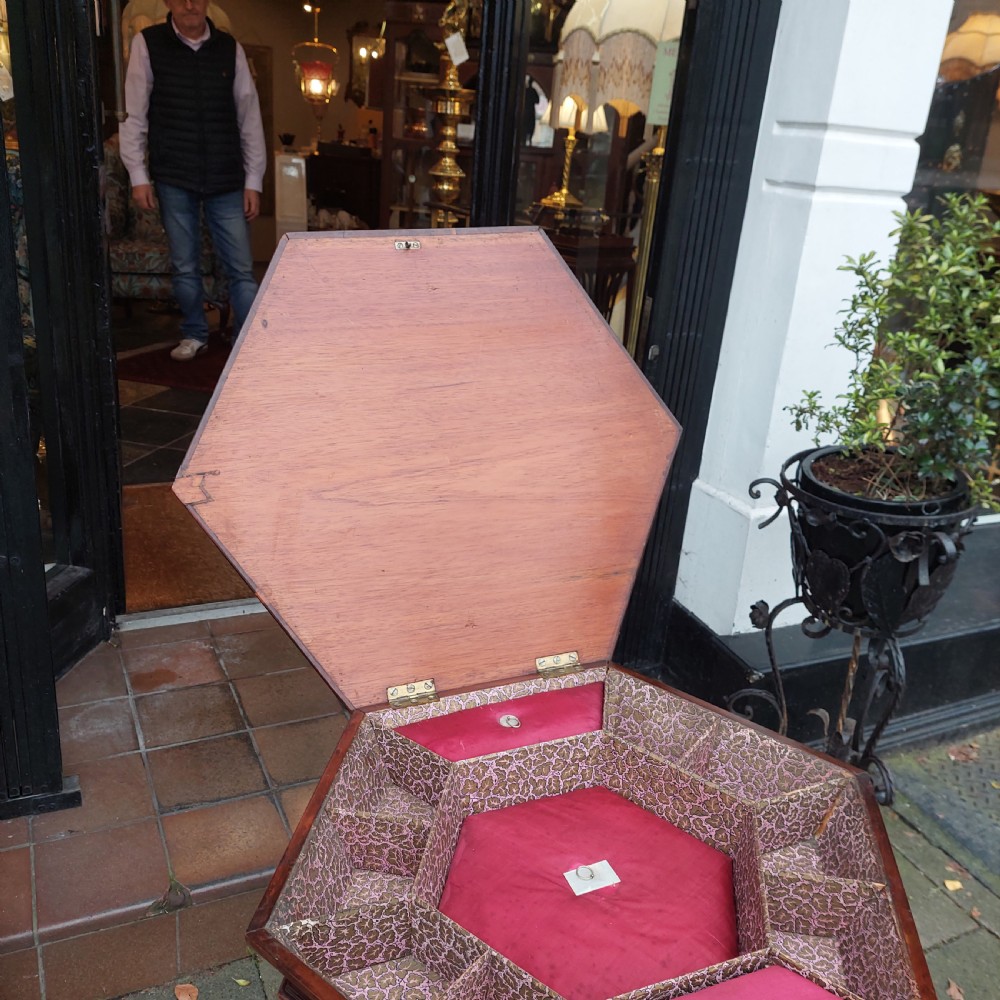 A 19th-century octagonal yew wood work table featuring a hinged top lid, a tapered central body, and carved tripod legs. View IX