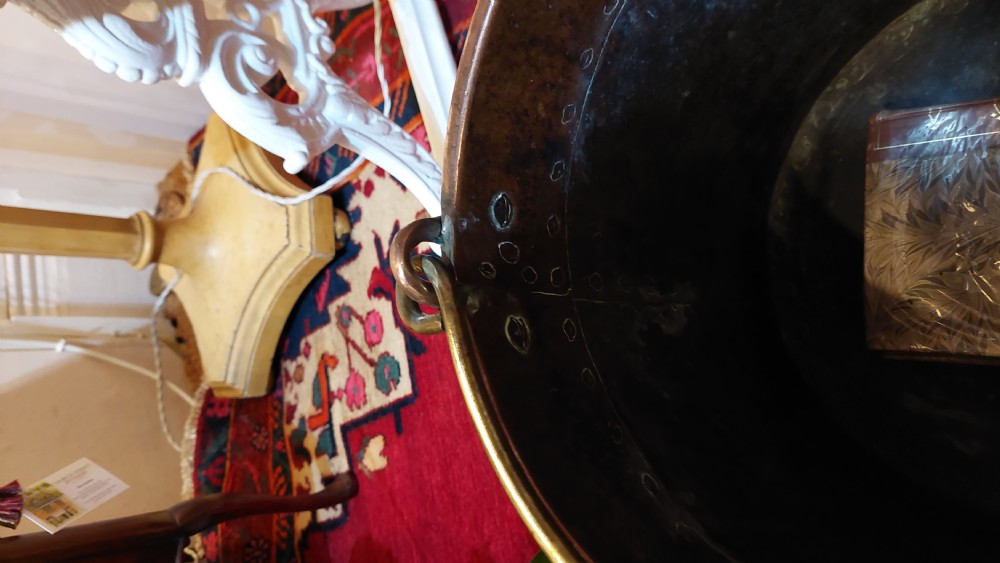 A circular Victorian copper log bucket featuring visible rivet construction along the seams and a brass swing handle. View IV