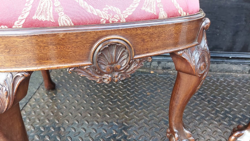 A pair of late 19th-century Queen Anne style carved mahogany side chairs with shell motif crests, splat backs, cabriole legs with claw and ball feet, and red patterned fabric seats. View III