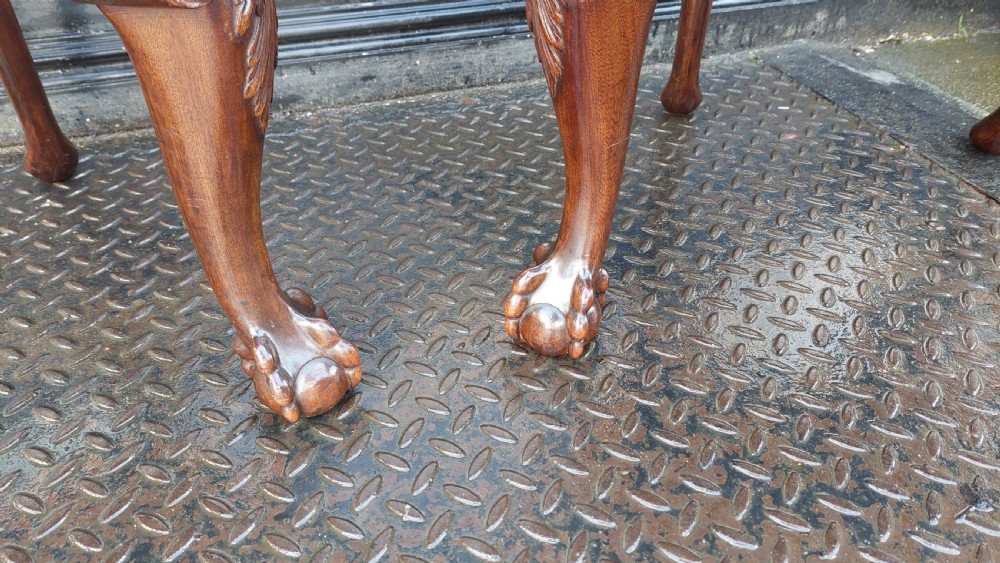 A pair of late 19th-century Queen Anne style carved mahogany side chairs with shell motif crests, splat backs, cabriole legs with claw and ball feet, and red patterned fabric seats. View IV