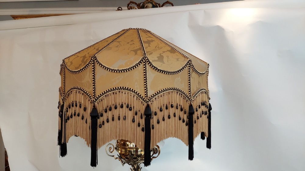 An ornate Victorian brass adjustable standard lamp featuring a scrolled tripod base with paw feet and a fabric shade with fringed tassels. View IV