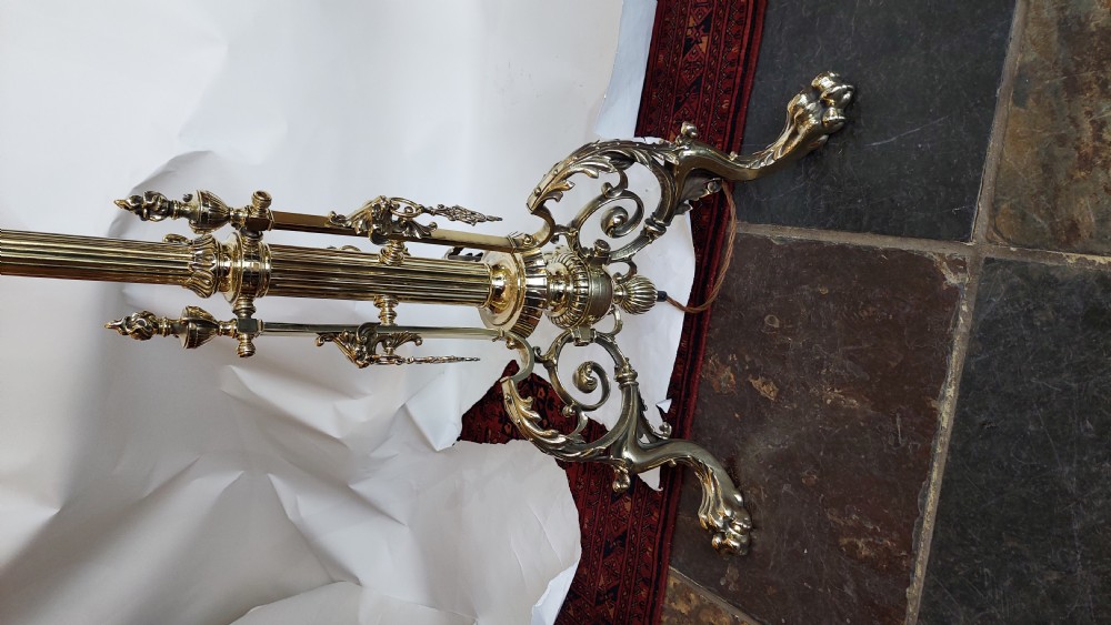 An ornate Victorian brass adjustable standard lamp featuring a scrolled tripod base with paw feet and a fabric shade with fringed tassels. View VI