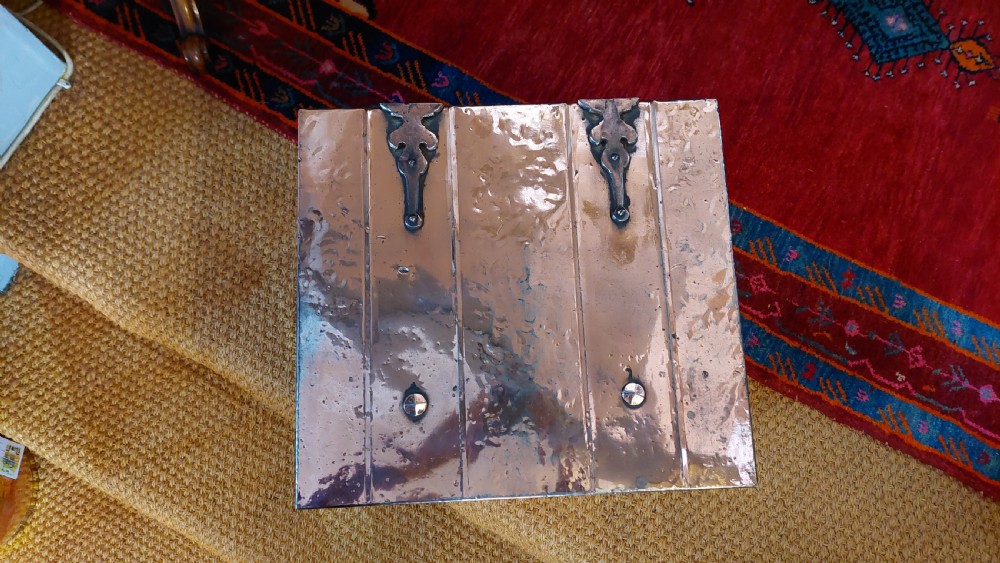 A late 19th-century square copper-plated coal box featuring a hammered finish, hinged lid, drop side handles, and decorative metal studs along the base. View IV