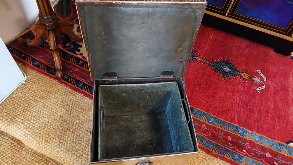 A late 19th-century square copper-plated coal box featuring a hammered finish, hinged lid, drop side handles, and decorative metal studs along the base. View V