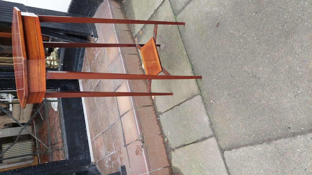 An Edwardian mahogany torchere stand featuring an octagonal top with satinwood inlay, four slender splayed legs, and a square lower undertier. View V