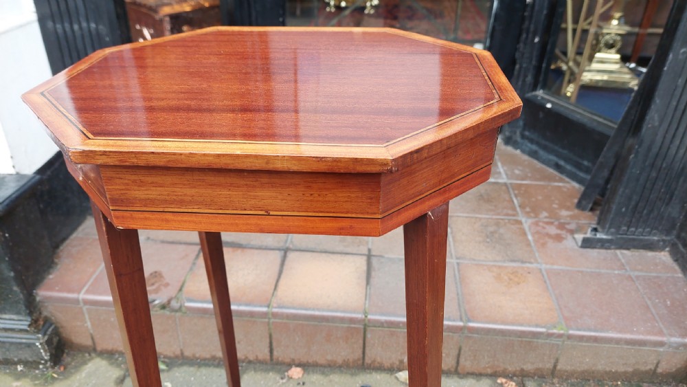 An Edwardian mahogany torchere stand featuring an octagonal top with satinwood inlay, four slender splayed legs, and a square lower undertier. View VII