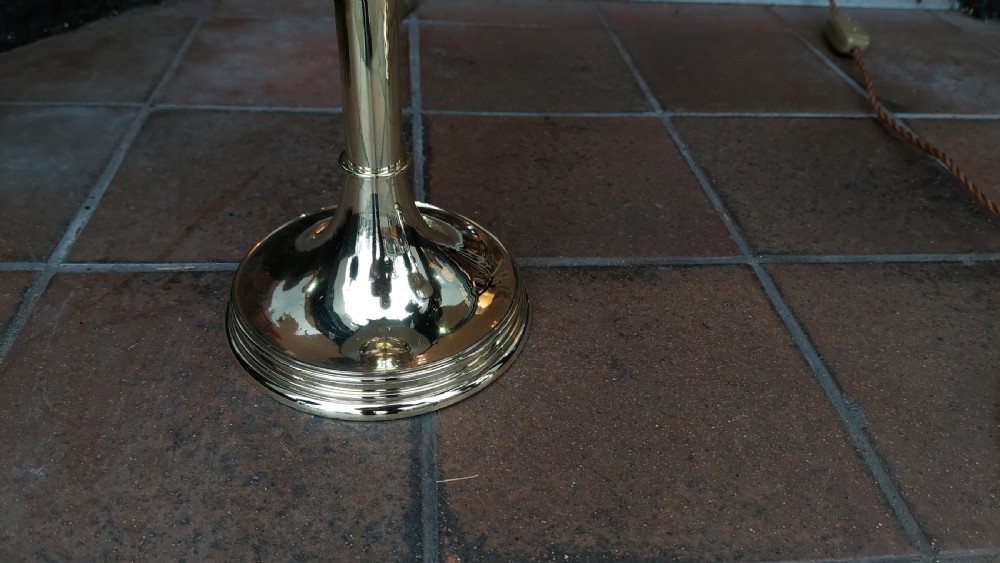 A pair of polished brass candlestands with turned stems, topped with blue tartan fabric shades featuring stag motif ribbons. View II