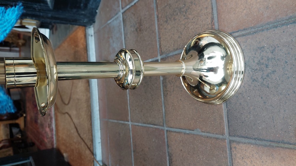 A pair of polished brass candlestands with turned stems, topped with blue tartan fabric shades featuring stag motif ribbons. View IV