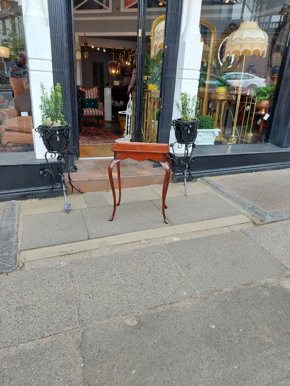 A 19th-century mahogany silver table featuring a raised tray top, shaped apron, and slender cabriole legs. View II