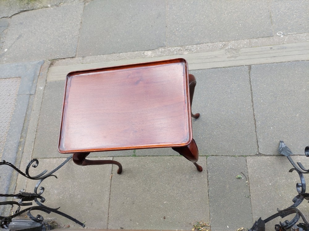 A 19th-century mahogany silver table featuring a raised tray top, shaped apron, and slender cabriole legs. View III