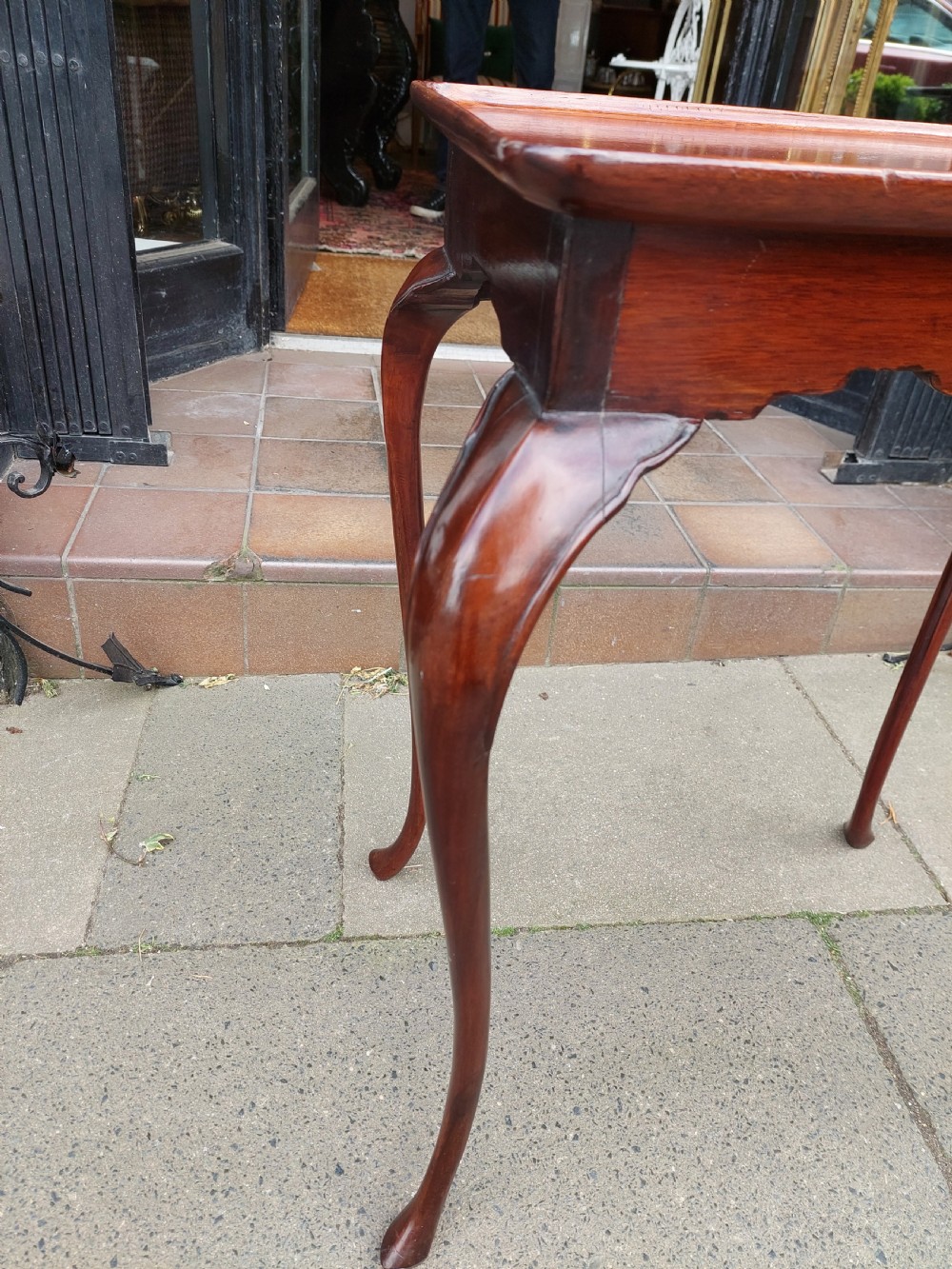 A 19th-century mahogany silver table featuring a raised tray top, shaped apron, and slender cabriole legs. View IV