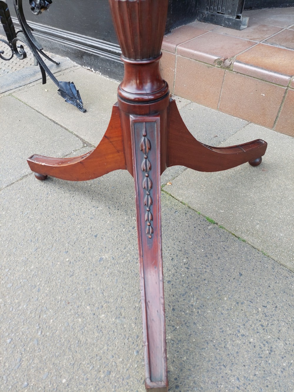A tall mahogany Adam Revival torchere stand featuring a fluted column, carved tripod legs, and a circular top. View III