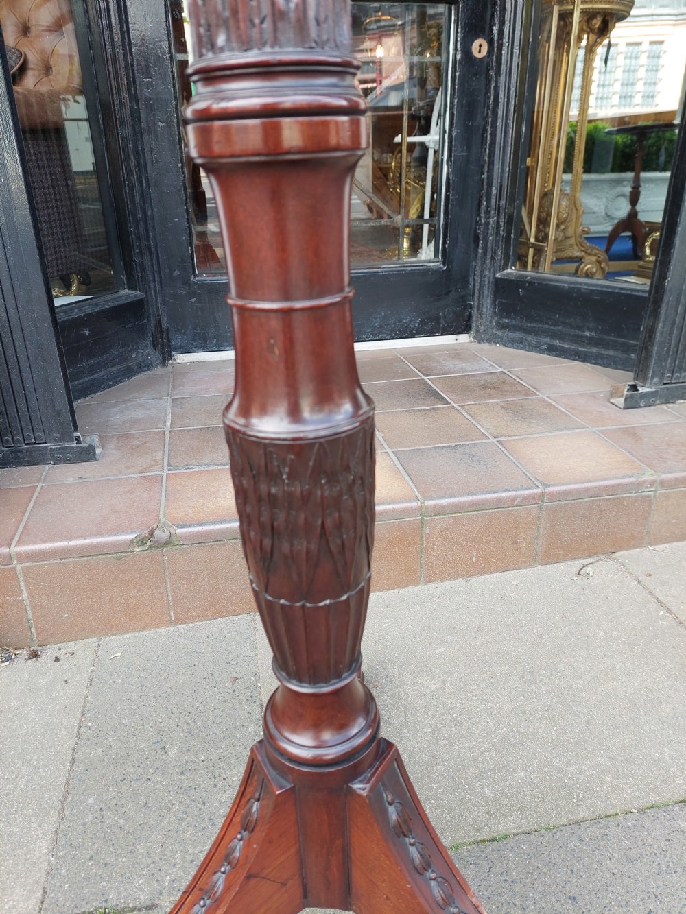 A tall mahogany Adam Revival torchere stand featuring a fluted column, carved tripod legs, and a circular top. View V