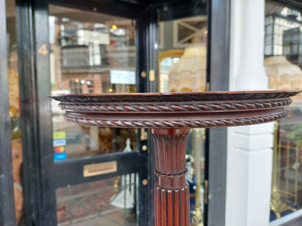 A tall mahogany Adam Revival torchere stand featuring a fluted column, carved tripod legs, and a circular top. View VIII