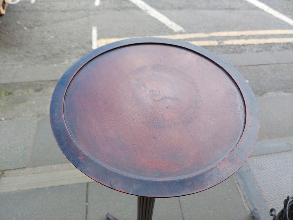A tall mahogany Adam Revival torchere stand featuring a fluted column, carved tripod legs, and a circular top. View X