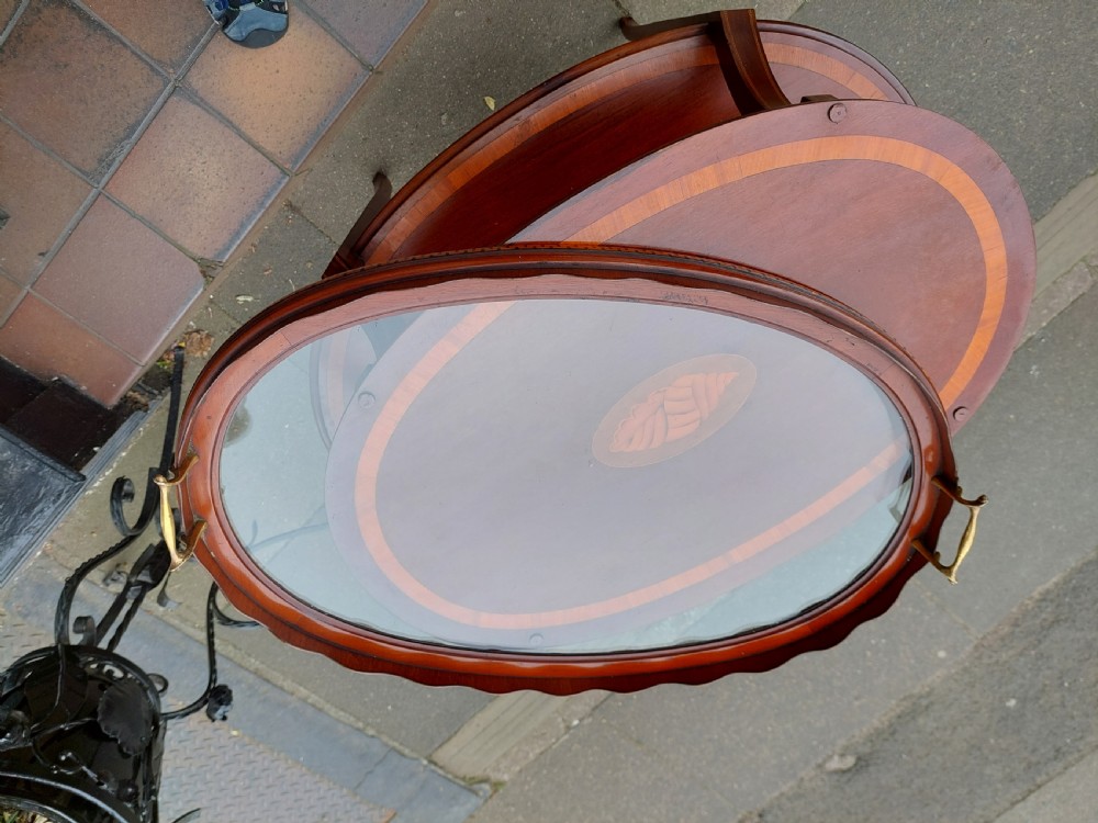 An Edwardian mahogany two-tier etagere table with satinwood oval inlays, brass side handles, and a removable glass tray top. View III