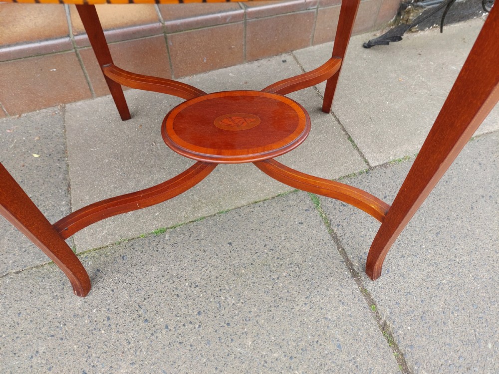 An Edwardian mahogany two-tier etagere table with satinwood oval inlays, brass side handles, and a removable glass tray top. View VIII