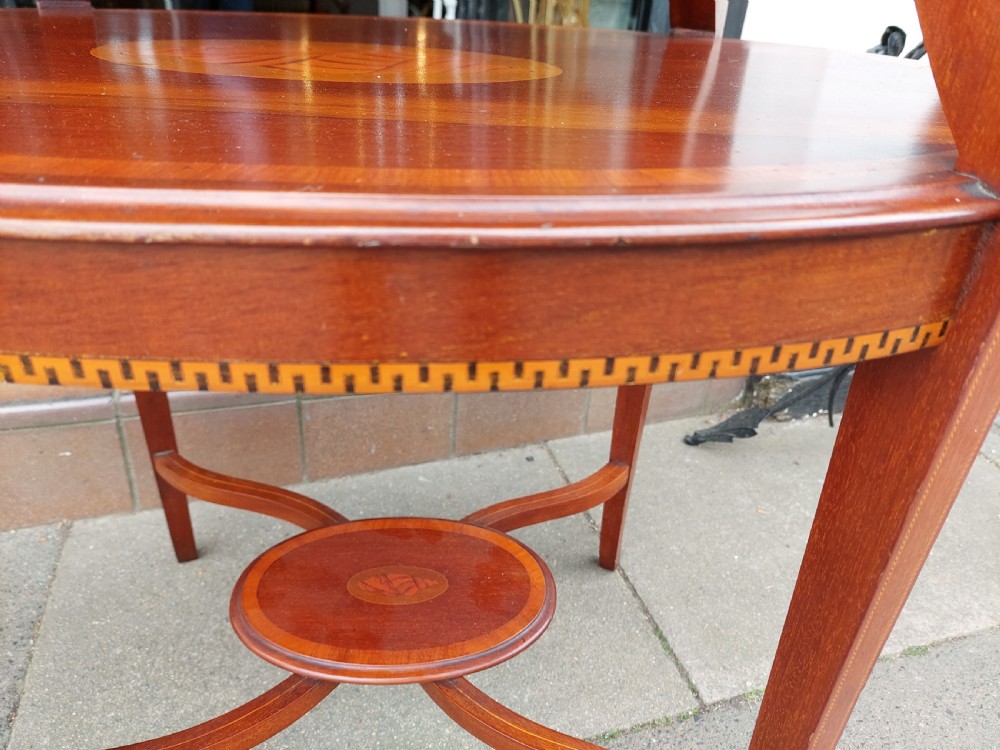 An Edwardian mahogany two-tier etagere table with satinwood oval inlays, brass side handles, and a removable glass tray top. View X