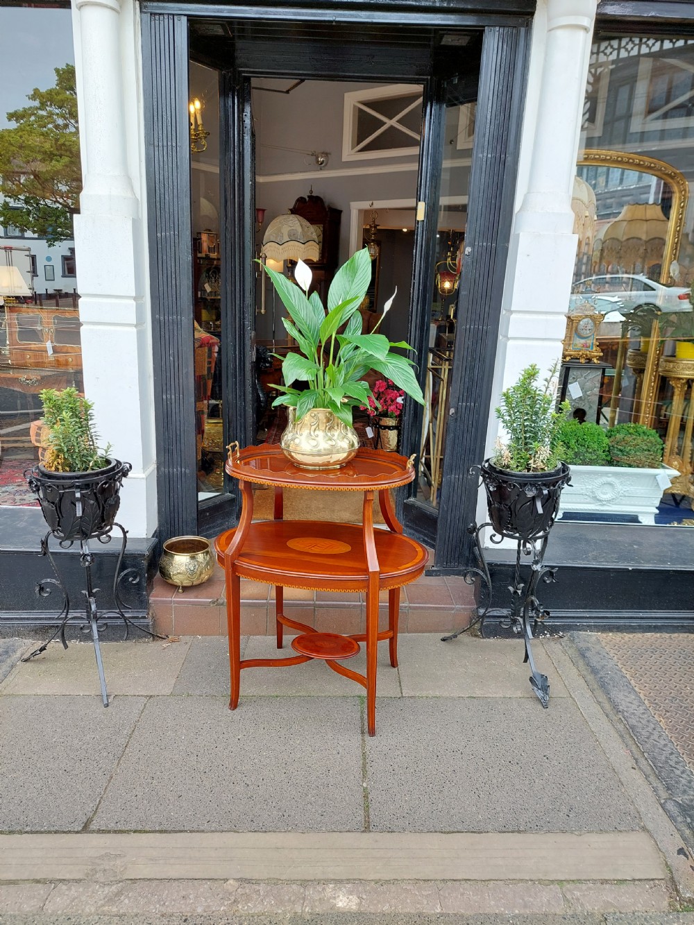 An Edwardian mahogany two-tier etagere table with satinwood oval inlays, brass side handles, and a removable glass tray top. View XII