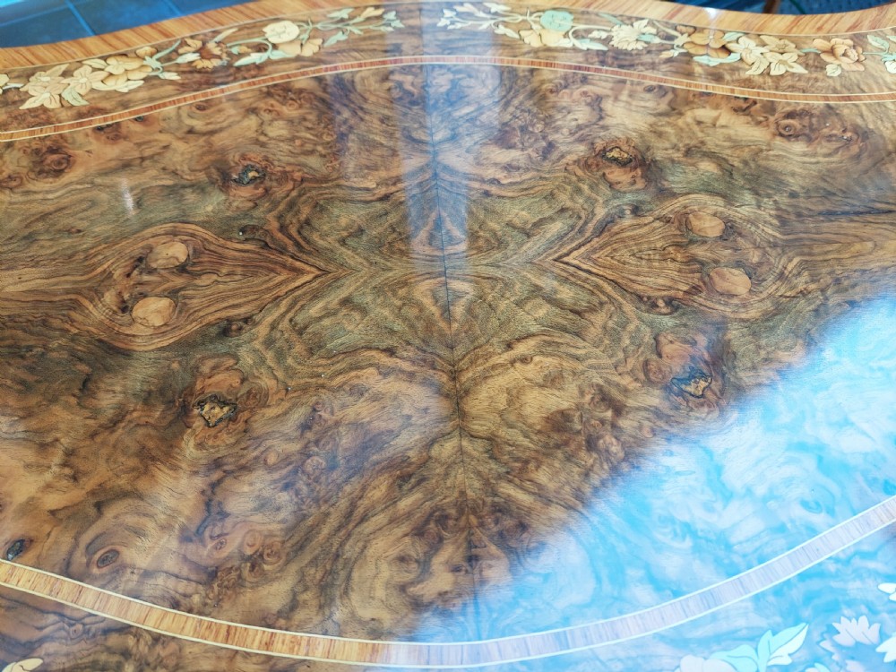 A 19th-century burr walnut bureau plat with a serpentine top featuring floral marquetry, gilt-bronze mounts, and cabriole legs. View VIII