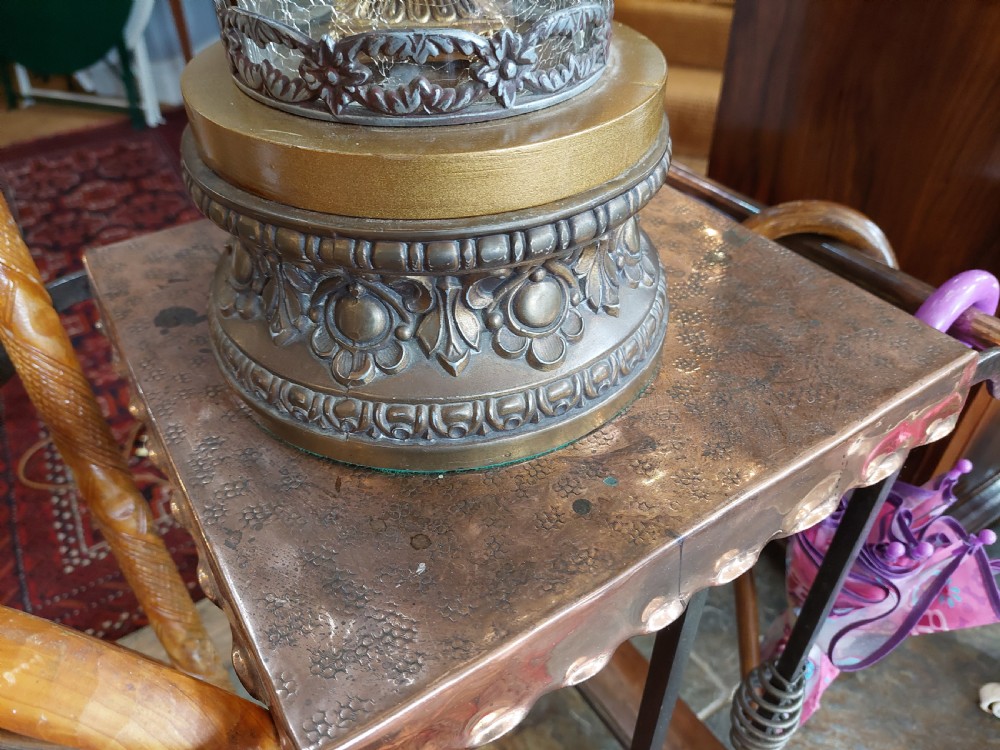 A pair of ornate gilded spelter table lamps featuring classical figures enclosed in glass columns topped with fringed cream fabric shades. View VI