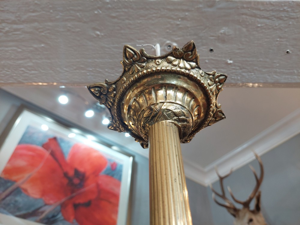 An early 20th-century French cast brass three-light chandelier featuring scrolled arms, a decorative pierced gallery ring, and frosted fluted glass shades. View VIII