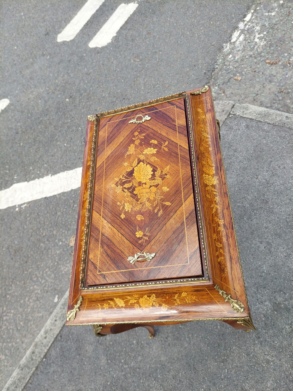 A Victorian kingwood jardiniere table featuring floral marquetry inlays, slender cabriole legs with gilt-metal mounts, and a brass gallery rim. View III