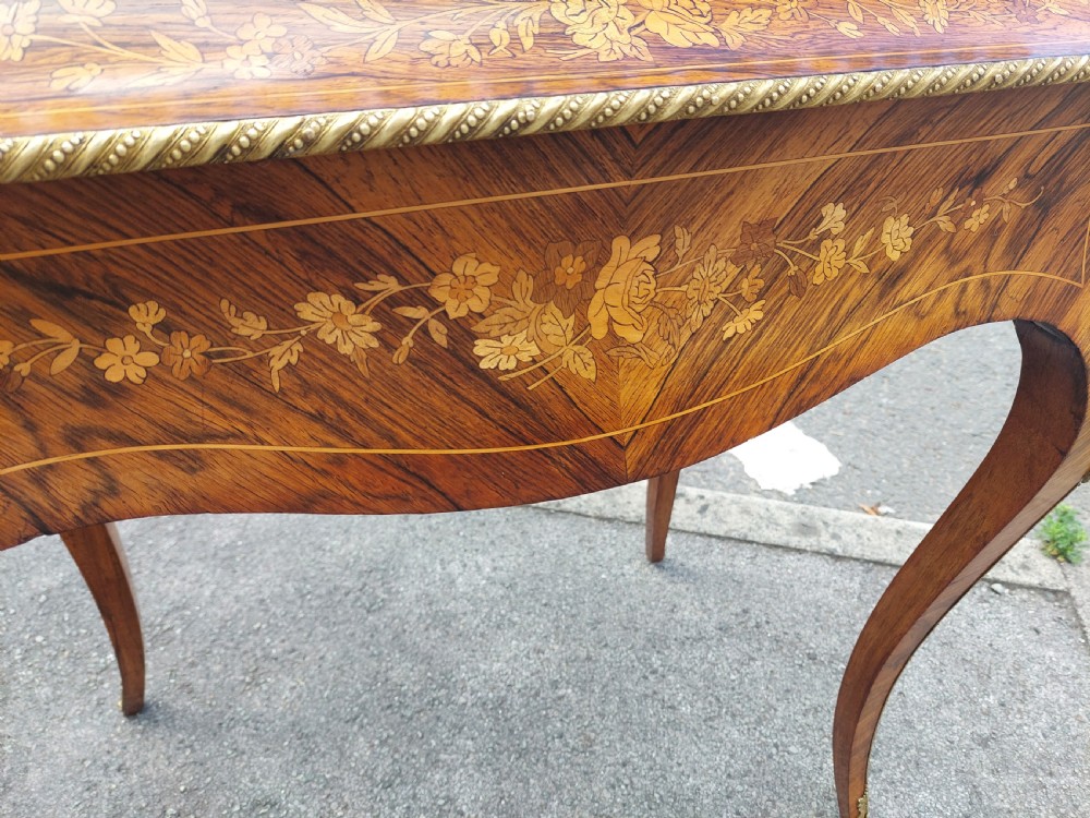 A Victorian kingwood jardiniere table featuring floral marquetry inlays, slender cabriole legs with gilt-metal mounts, and a brass gallery rim. View VII
